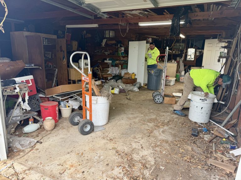 Alamo Bros crew clearing clutter inside a residential garage